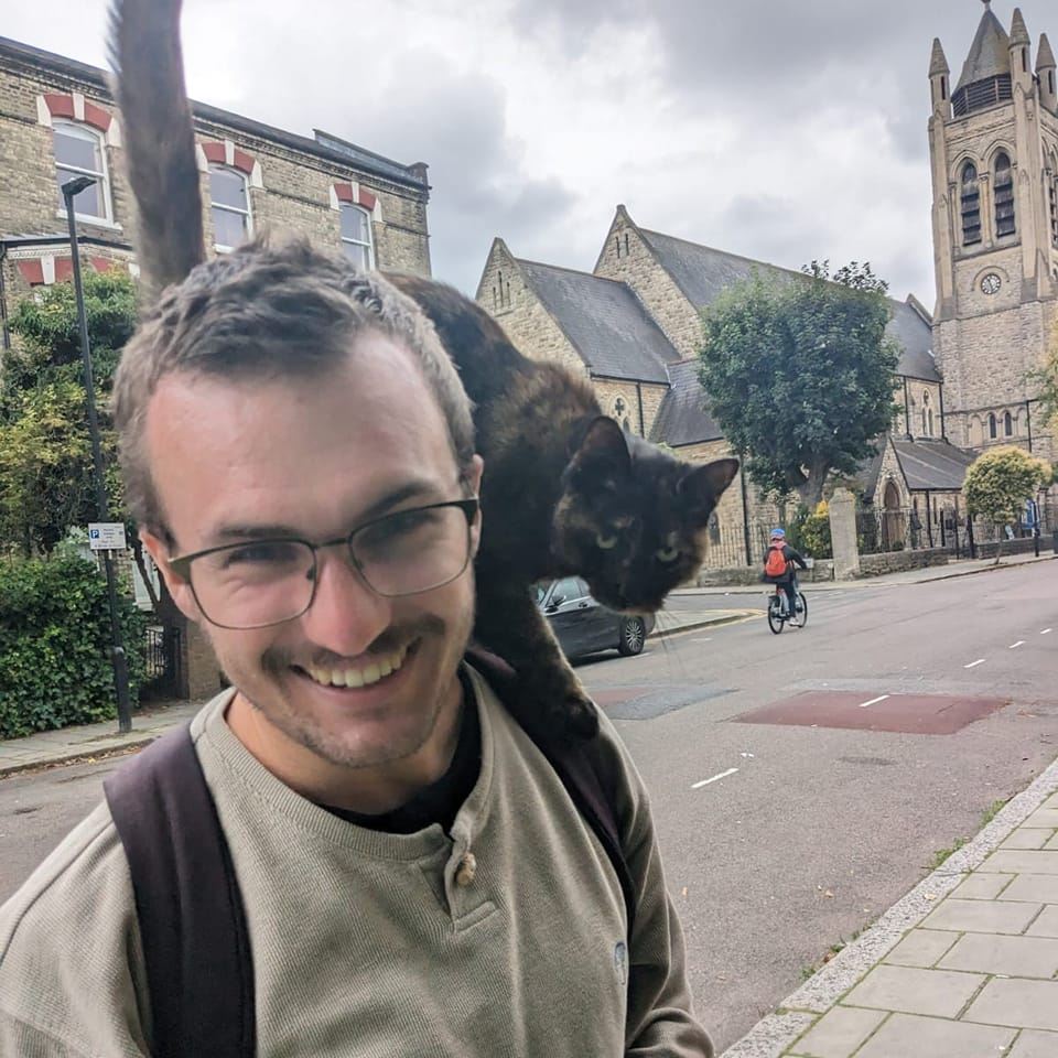 Matthew Allcock with a cat on his shoulder